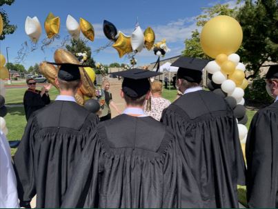 Graduates walking toward families