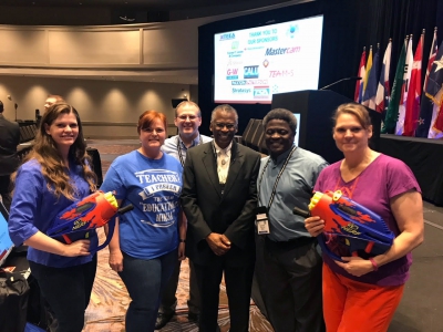 Weber School District Educators, pose for a picture with Lonnie Johnson, who is a former NASA engineer and inventor of the massively popular Super Soaker water gun at the the ITEEA conference.