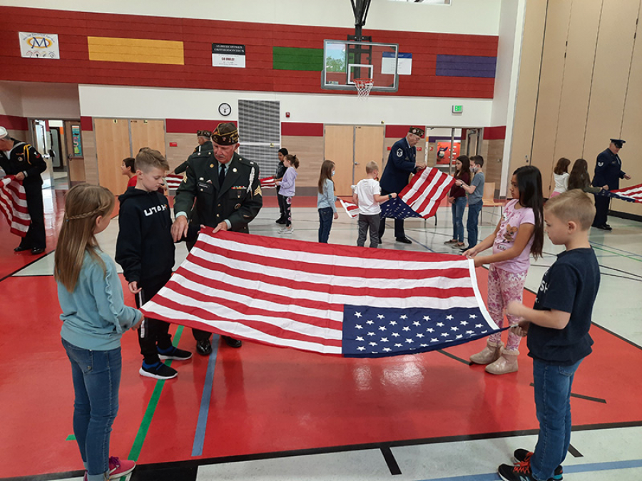 Orchard Spring Owls celebrating Veterans Day by learning about the flag and how to fold one.