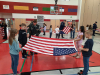 Orchard Spring Owls celebrating Veterans Day by learning about the flag and how to fold one. 