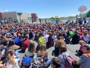 Students gather for the dedication of a new playground