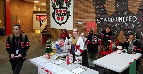 Weber Warriors raise money for charity, assist families with Quarter and Cans fundraiser